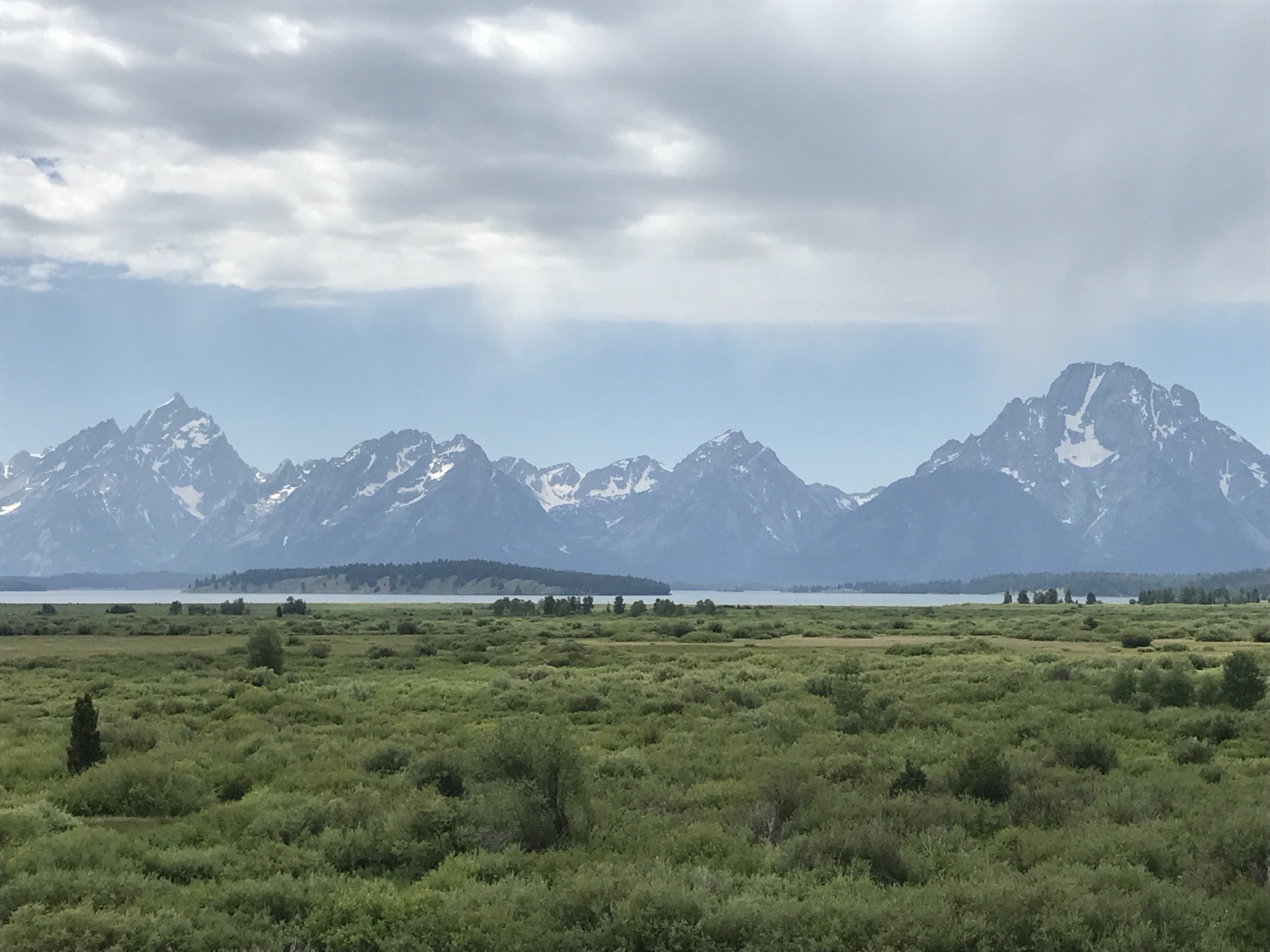 Mountain range beyond a green plain