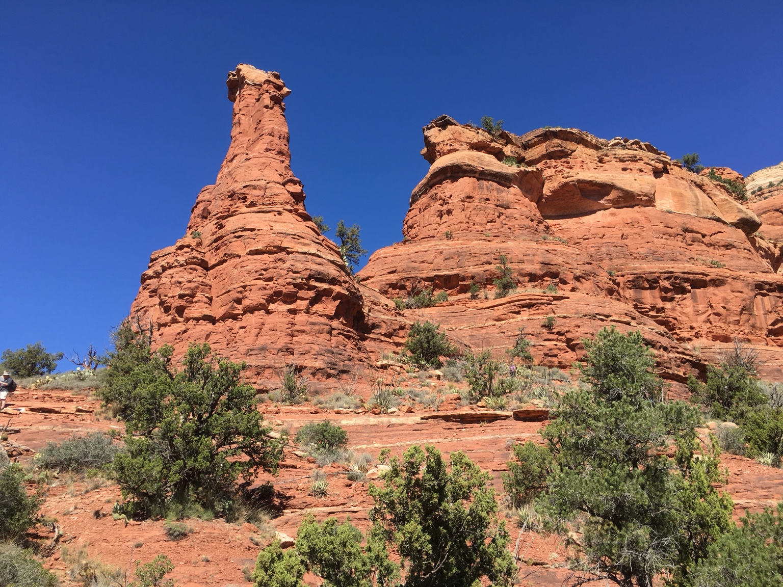 Red rock formations beneath a clear blue sky